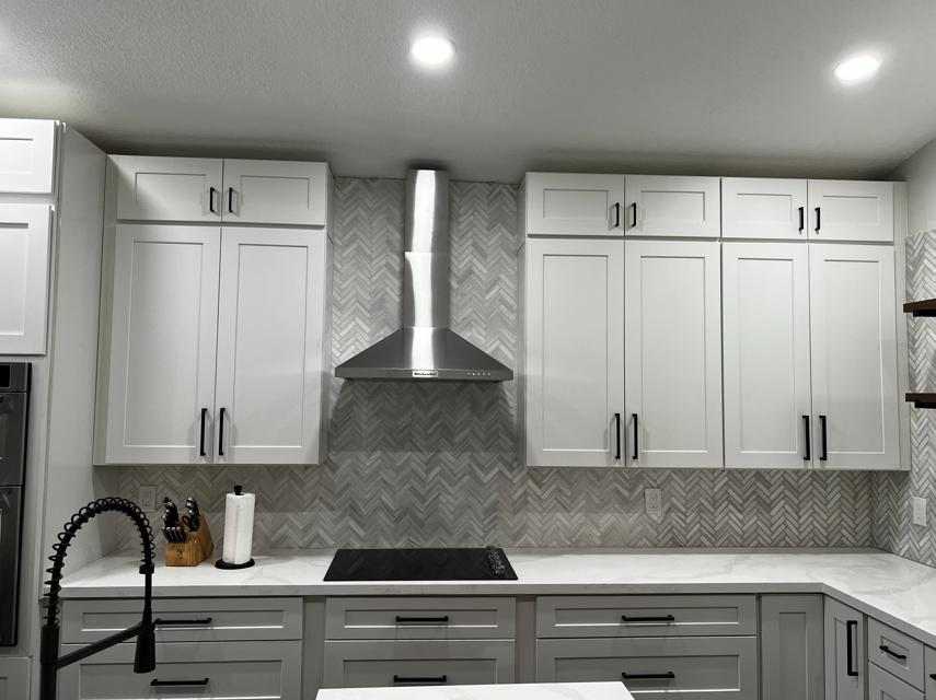 Herringbone backsplash with marble counters