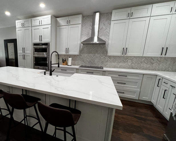 Calacatta peninsula with herringbone backsplash